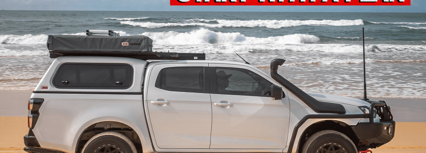 Isuzu D-MAX driving along a beach during a touring and remote travel adventure