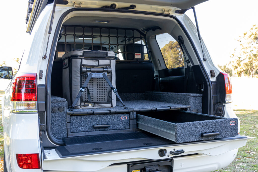 ARB drawer system with one drawer extended inside a Toyota LandCruiser 200 Series.