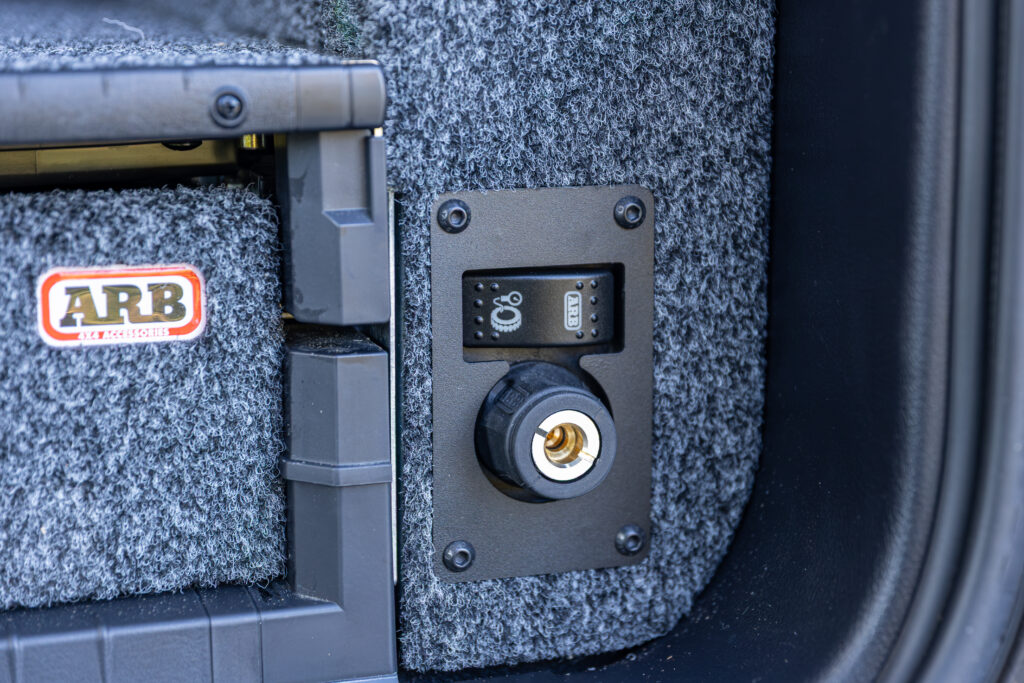 Close-up of an ARB air outlet and switch panel integrated into the rear drawer system.