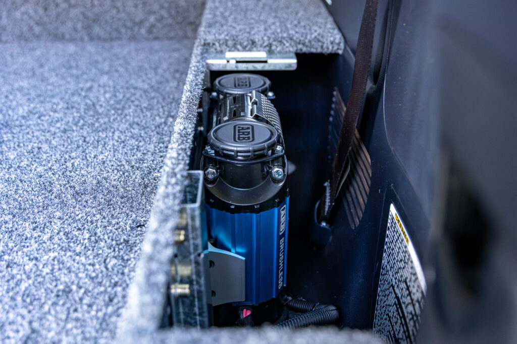 ARB brushless onboard air compressor mounted beside the rear drawer system in a Toyota LandCruiser 200 Series.