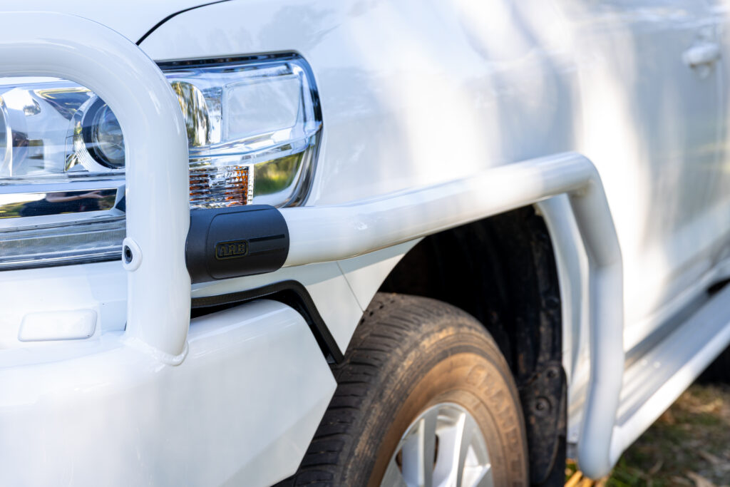 ARB side protection and side steps fitted to a white Toyota LandCruiser 200 Series.
