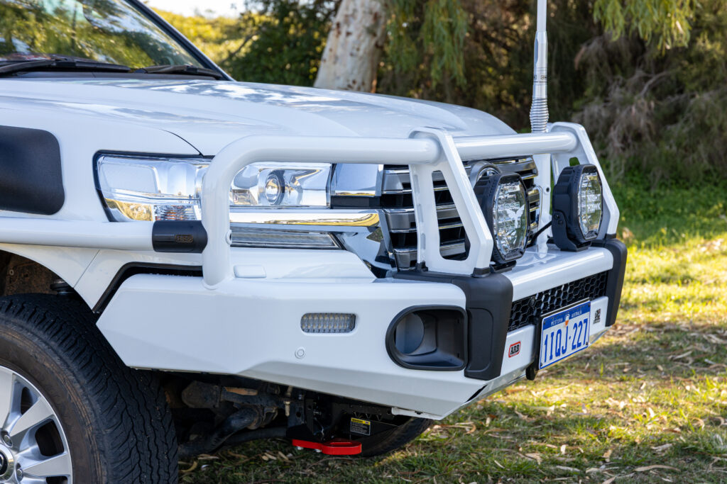 Close-up of the ARB Summit bull bar, Night Hawk driving lights and front recovery points on a Toyota LandCruiser 200 Series.