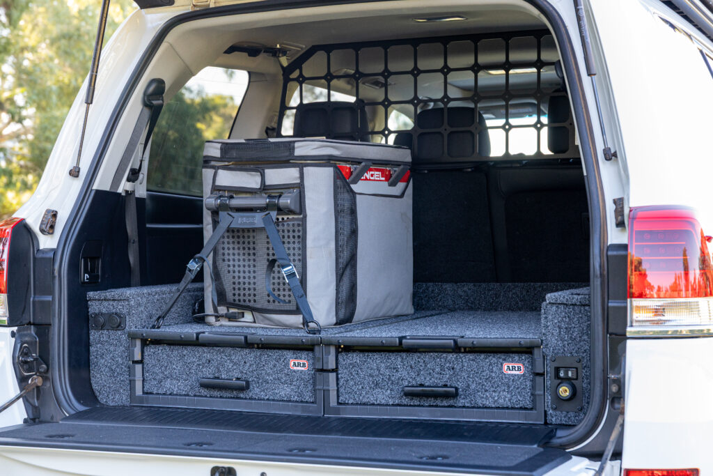 ARB rear drawer system installed in a Toyota LandCruiser 200 Series with fridge slide and cargo barrier.