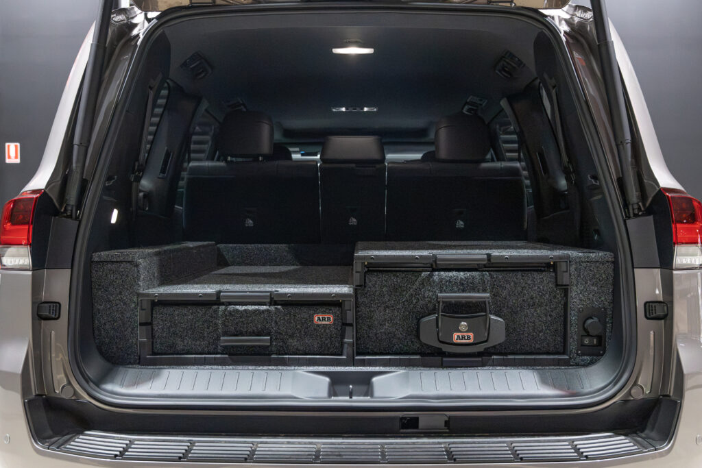 Rear cargo area of Rick's Toyota LandCruiser 300 Series featuring an ARB drawer system and on-board compressor controls.