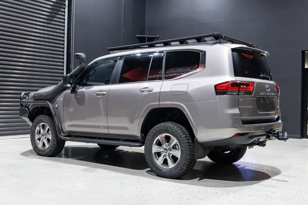 Rear passenger side view of Rick's Toyota LandCruiser 300 Series showcasing the ARB Base Rack and touring modifications.