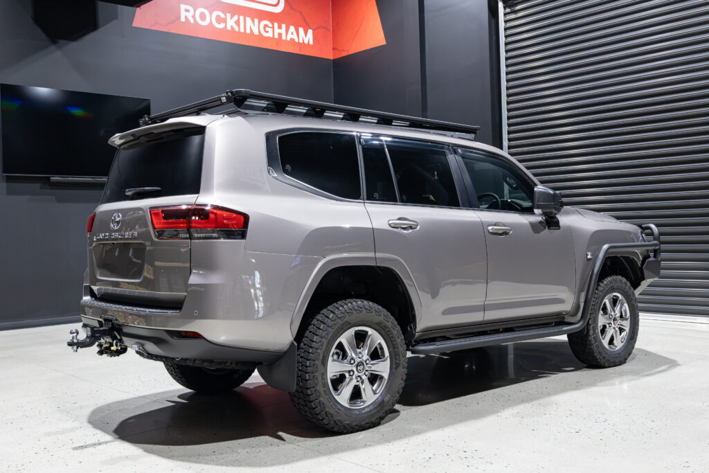 Rear three quarter view of Rick's Toyota LandCruiser 300 Series featuring ARB Base Rack, MT-64 suspension and tow setup.