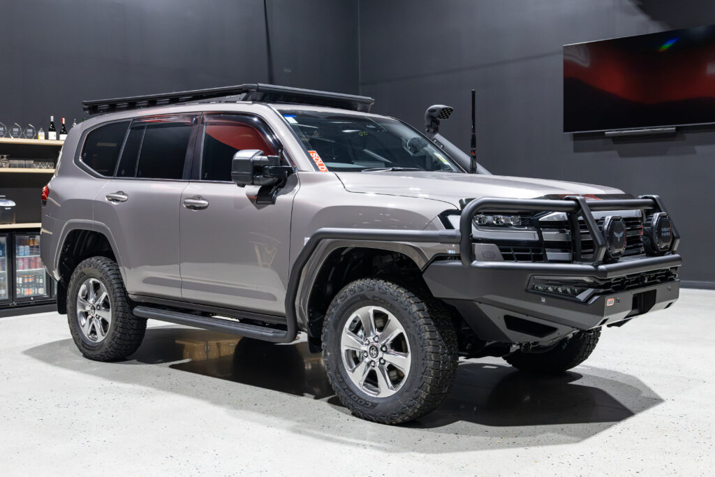 Front three quarter view of Rick's Toyota LandCruiser 300 Series fitted with an ARB Summit MKII Bull Bar, Bushranger Nighthawk driving lights and Safari snorkel.