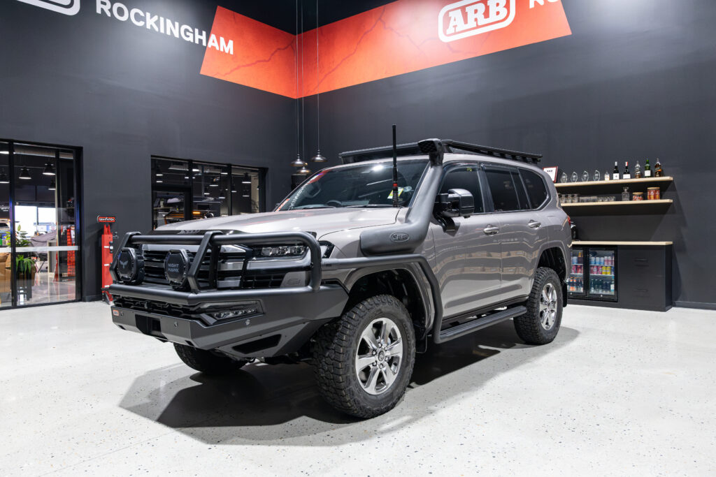 Front three quarter view of Rick's Toyota LandCruiser 300 Series fitted with an ARB Summit MKII Bull Bar, Bushranger Nighthawk driving lights and Safari snorkel.