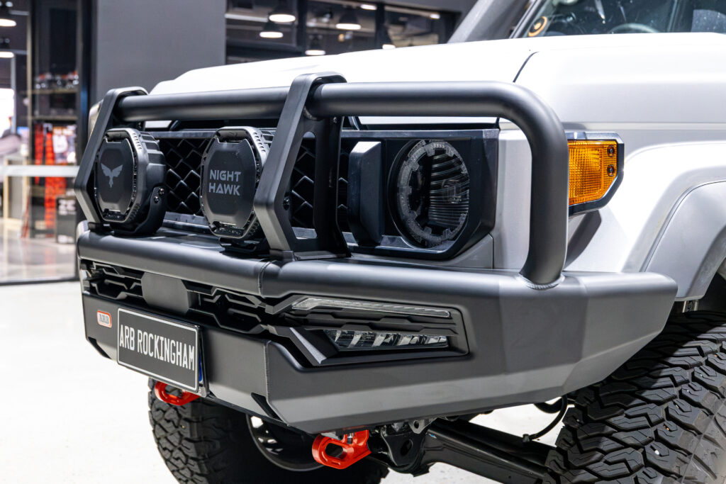 Close up of the ARB Summit MKII bullbar fitted with Bushranger Nighthawk 9 inch driving lights on a Toyota LandCruiser 79 Series.