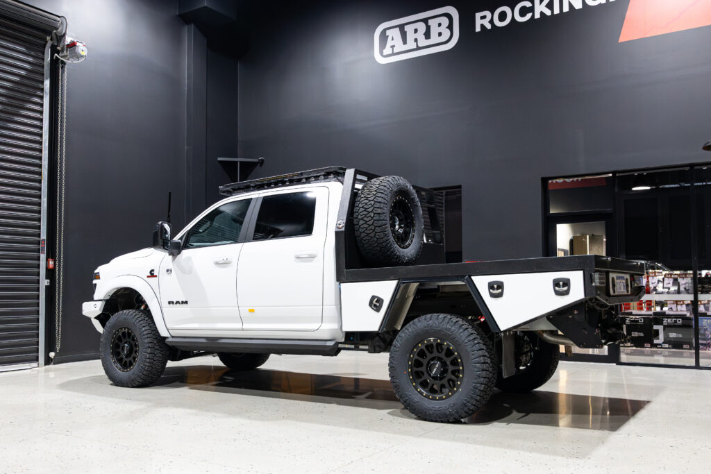 Rear three-quarter view of Kyle's RAM 2500 with custom tray and touring accessories