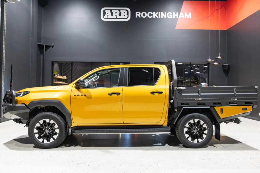 Side view of an N90 Toyota HiLux fitted with a MITS Alloy tray and colour coded undertray toolboxes