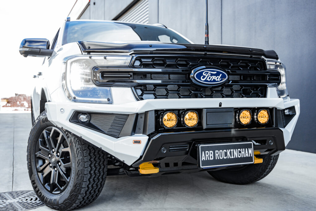 Front view of a white Ford Everest with an ARB Zenith Bull Bar, four ARB Nacho lights and recovery points