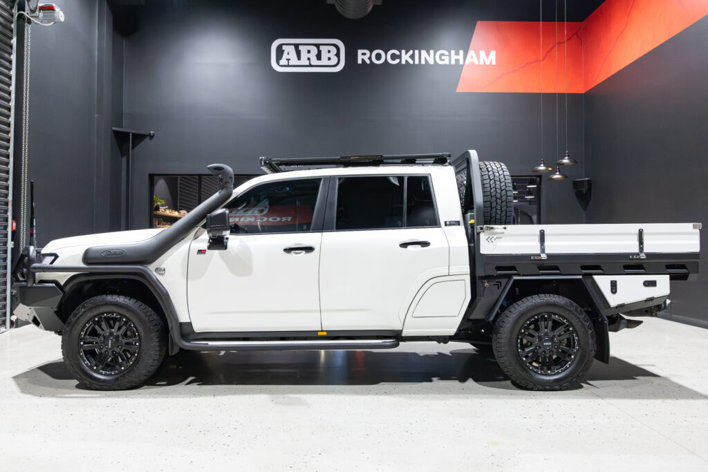 Side view of Tania’s chopped Toyota LC300 fitted with a MITS Alloy tray, ARB Base Rack, snorkel and Summit side rails