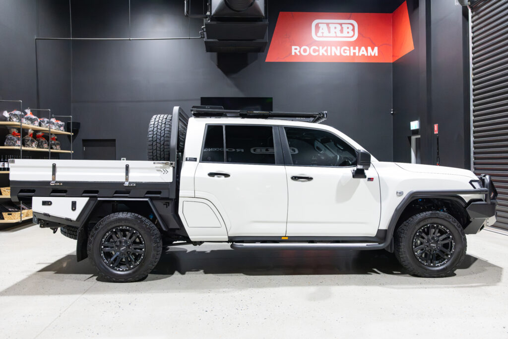 Side view of Tania’s chopped Toyota LC300 with MITS Alloy tray, ARB Base Rack and Summit side rails
