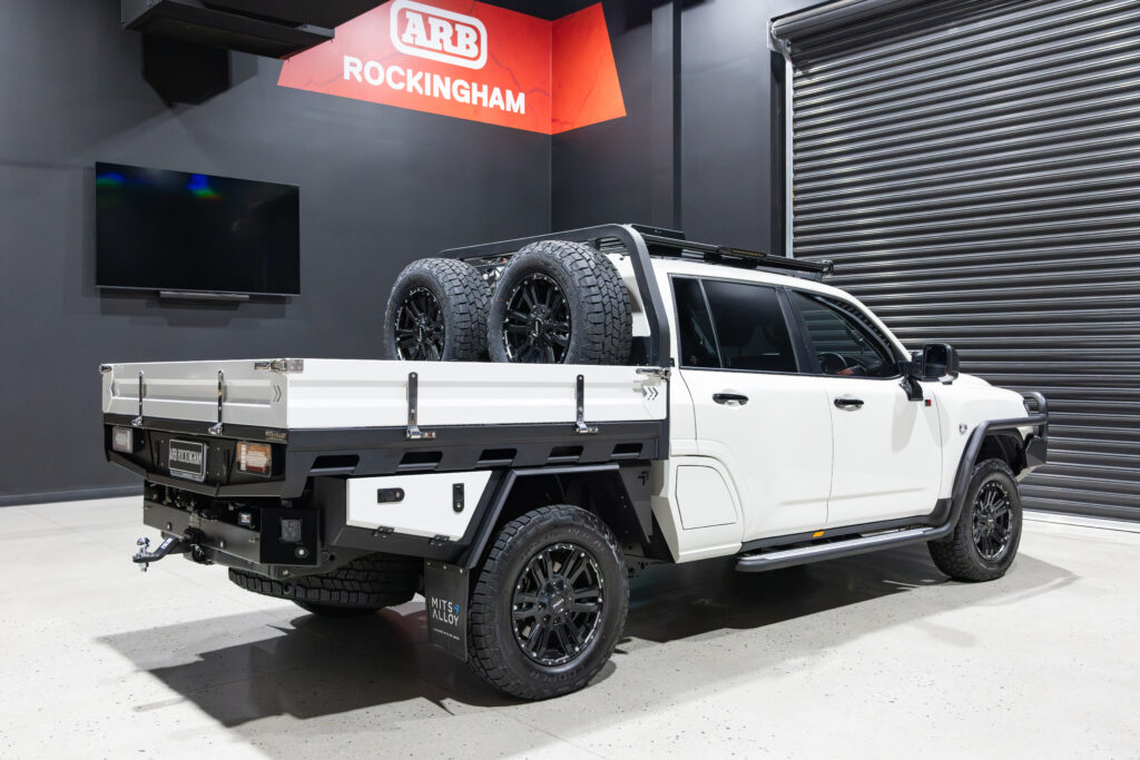Rear three-quarter view of Tania’s chopped Toyota LC300 with MITS Alloy tray and twin spare wheel setup
