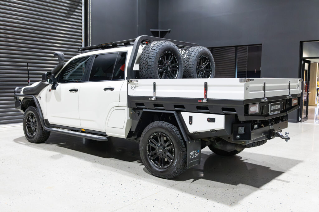 Rear three-quarter view of Tania’s chopped LC300 with MITS Alloy tray, undertray toolboxes and twin spare wheels