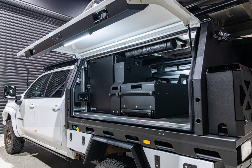 MITS Alloy canopy interior with storage, fridge and touring setup in Neal’s Silverado 2500