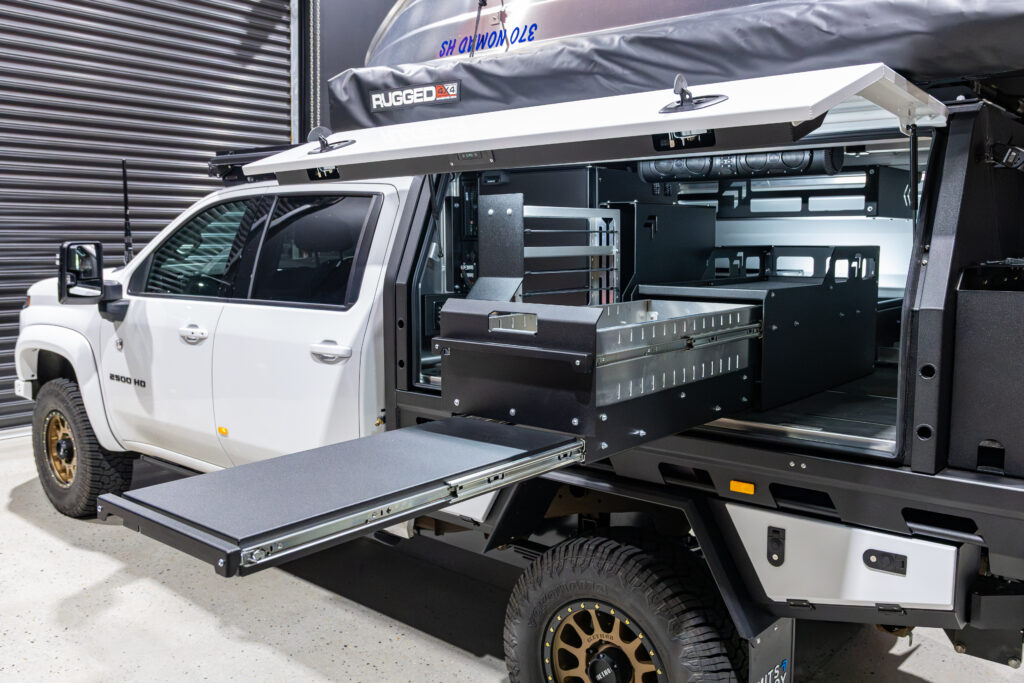 MITS Alloy canopy interior with storage, fridge and touring setup in Neal’s Silverado 2500