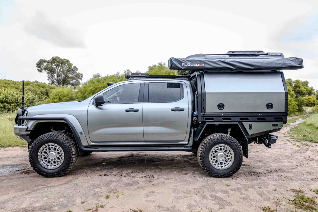 Full side view of a Ford Super Duty with MITS Alloy tray and canopy, ARB side rails, Base Rack and touring accessories