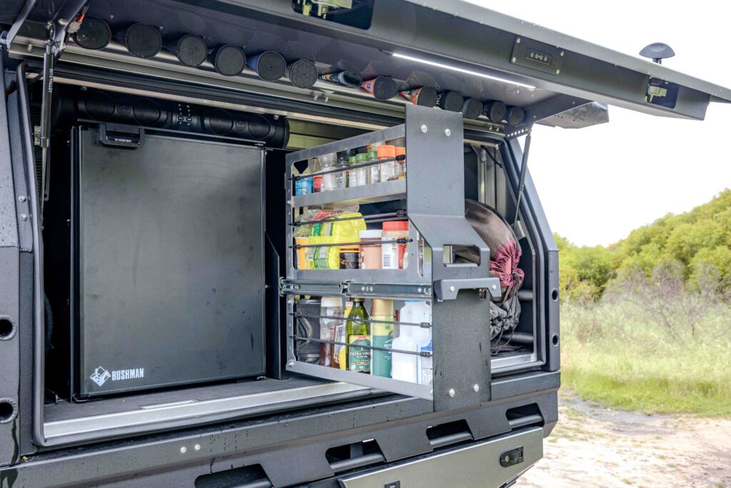 MITS Alloy canopy interior with Bushman upright fridge and pull-out pantry fitted to a Ford Super Duty touring build