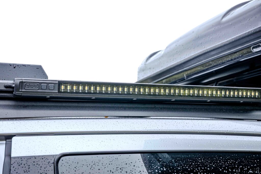 Close-up of an ARB Base Rack strip auxiliary light fitted to the Ford Super Duty roof rack