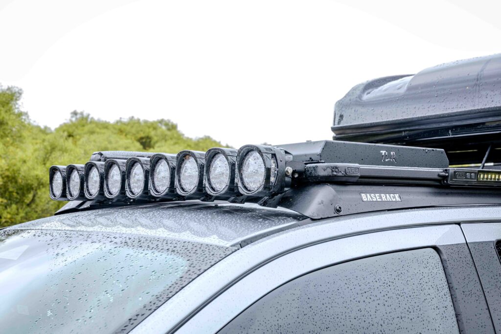 Roof-mounted Nacho Quatro spotlights, ARB Base Rack and TLR mount on a Ford Super Duty touring build
