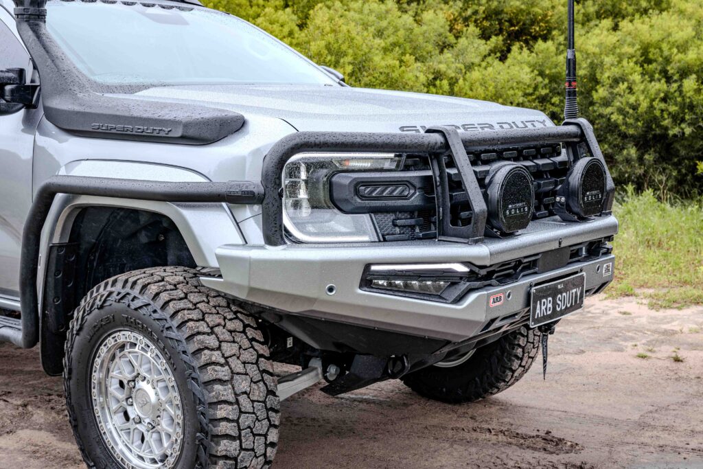 Close-up of an ARB Summit MKII Bull Bar and ARB Solis driving lights fitted to a Ford Super Duty