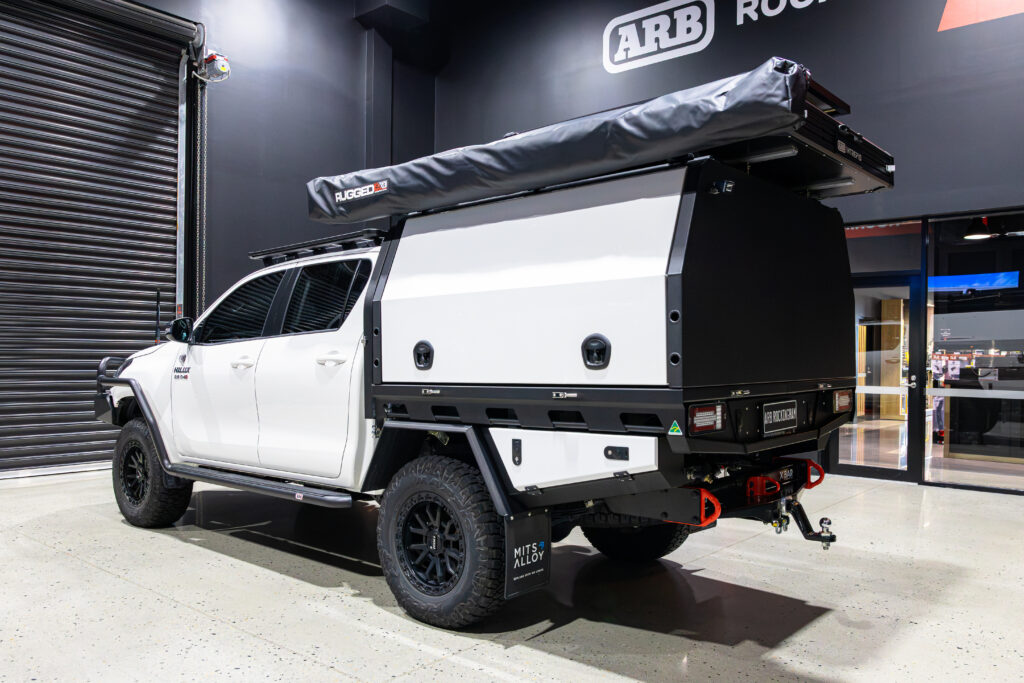 Rear three-quarter view of Michael’s Toyota Hilux fitted with a MITS Alloy tray and canopy, ARB Intrepid rooftop tent and touring accessories