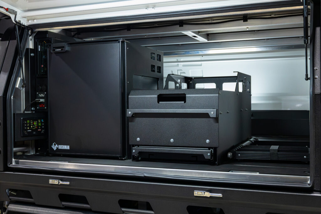 Interior of the Toyota Hilux MITS Alloy canopy with Bushman 85L upright fridge, drawer unit and REDARC electrical setup