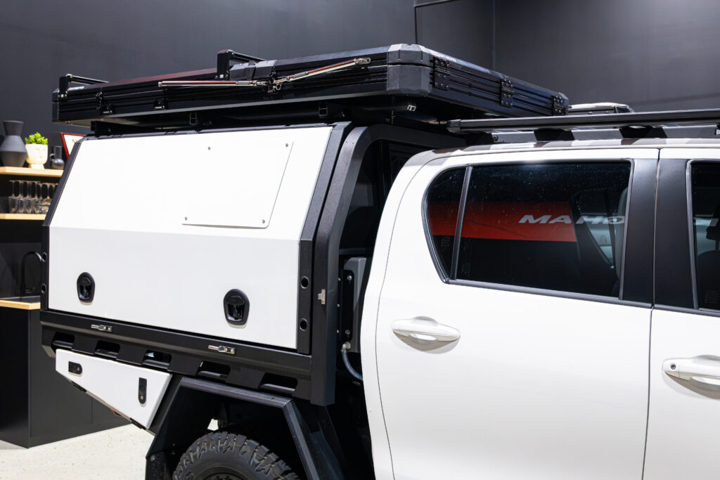 Close-up of the MITS Alloy canopy and ARB Intrepid rooftop tent fitted to the Toyota Hilux touring build