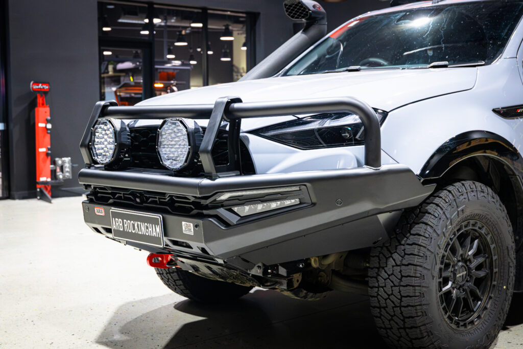 Close-up of an ARB Summit MKII Bull Bar and Bushranger Night Hawk driving lights fitted to an Isuzu MU-X