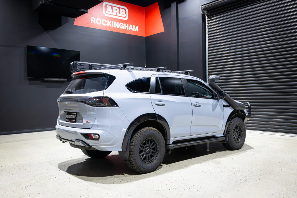 Rear three-quarter view of an Isuzu MU-X fitted with a Rhino-Rack Backbone and Sportz Bars